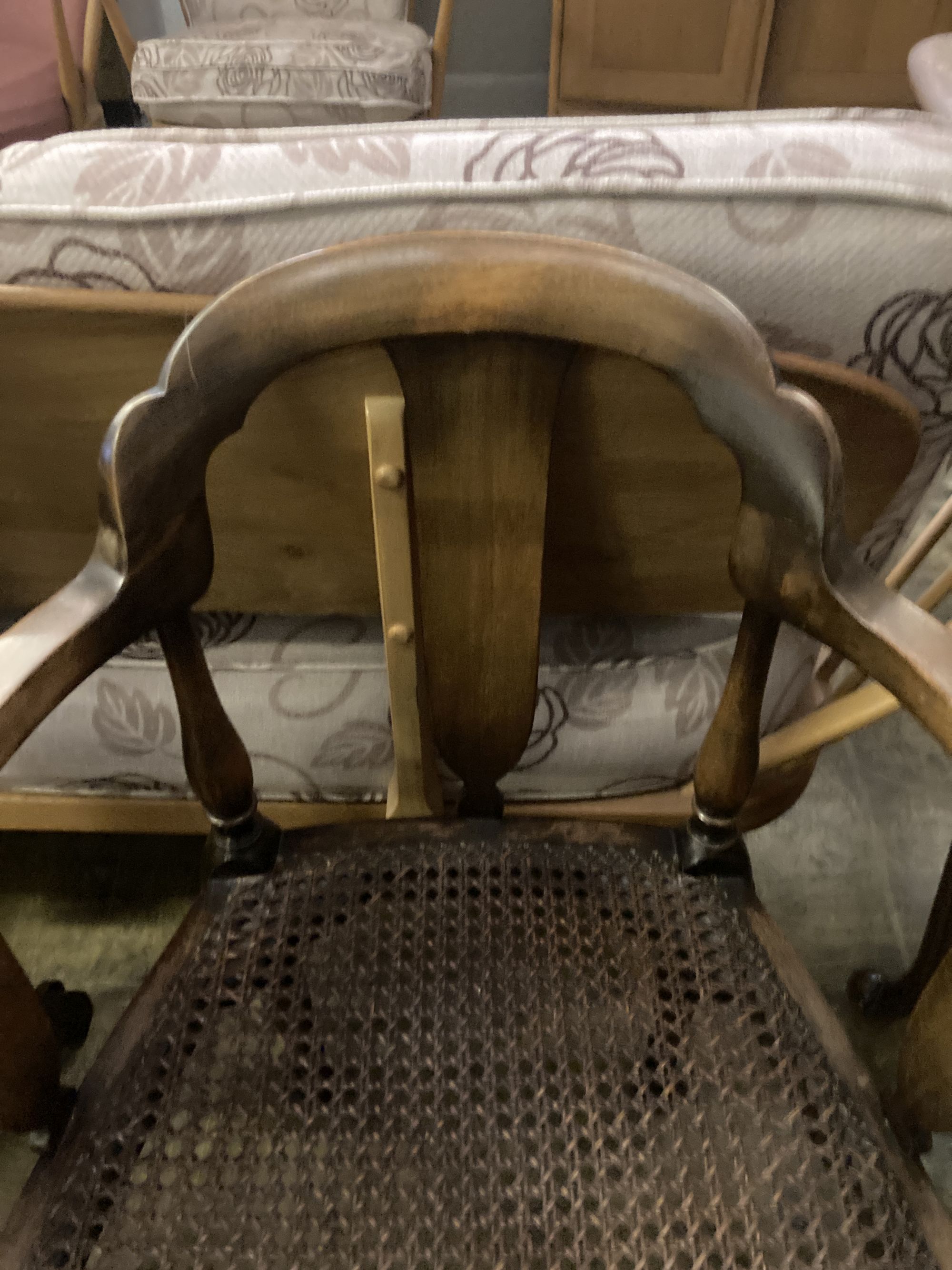 A 1920s circular caned beech occasional table, diameter 76cm, together with a pair of elbow chairs, one with a later tapestry seat